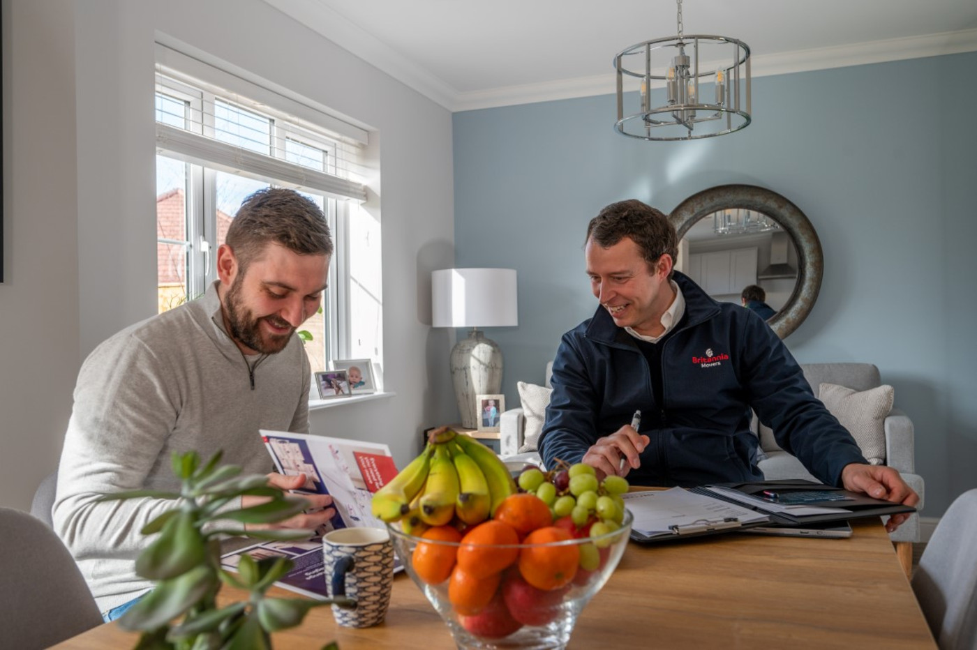 Surveyor with man at dining table